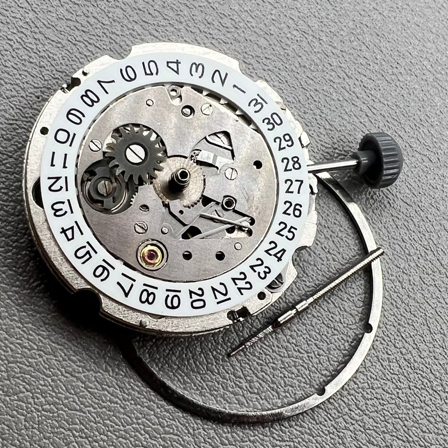 Close-up of Japan Miyota 8200 movement with single date display at 3 o'clock on watch accessory.