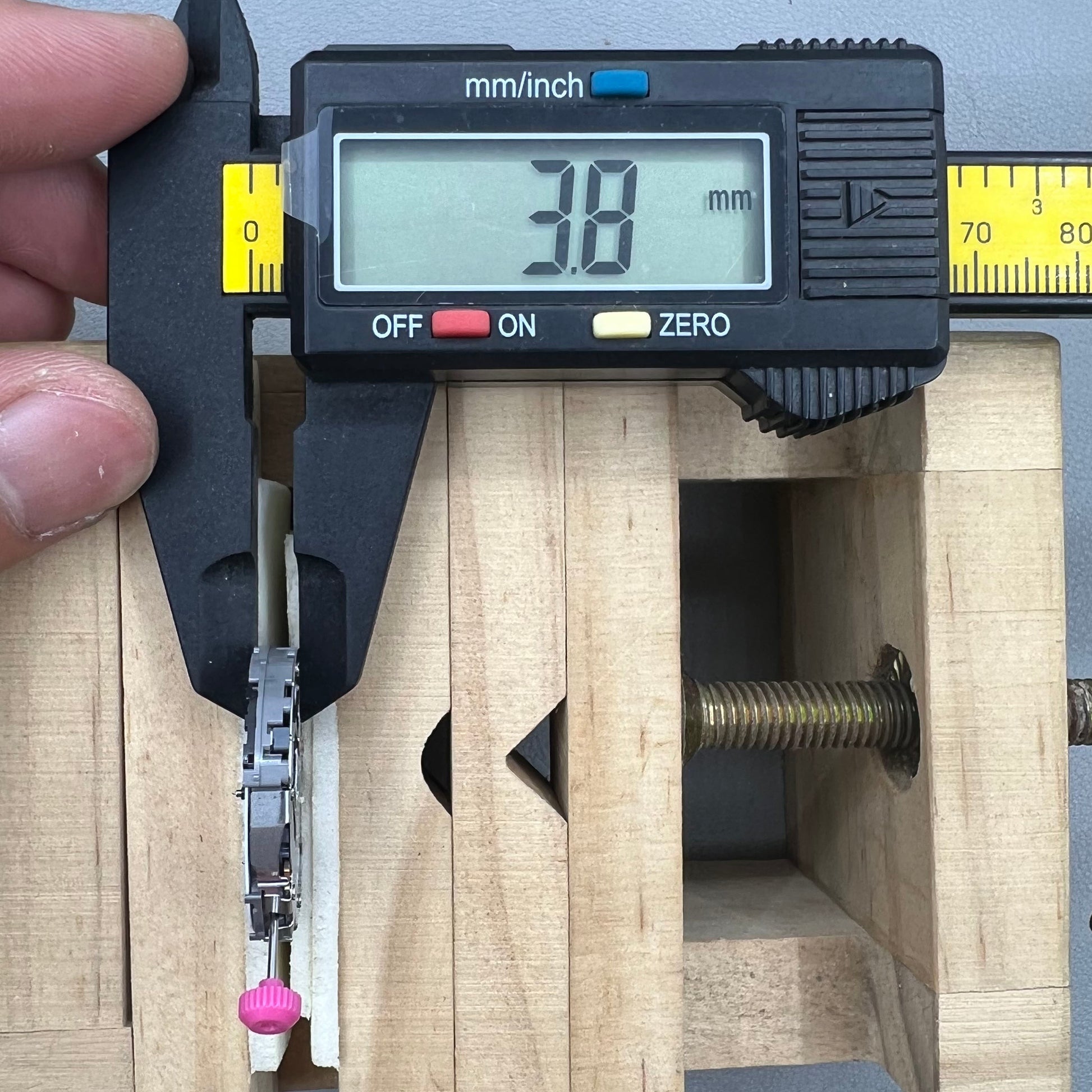 Japan Miyota JS25 watch movement close-up showing small second subdials at 3, 6, and 9 o'clock positions.