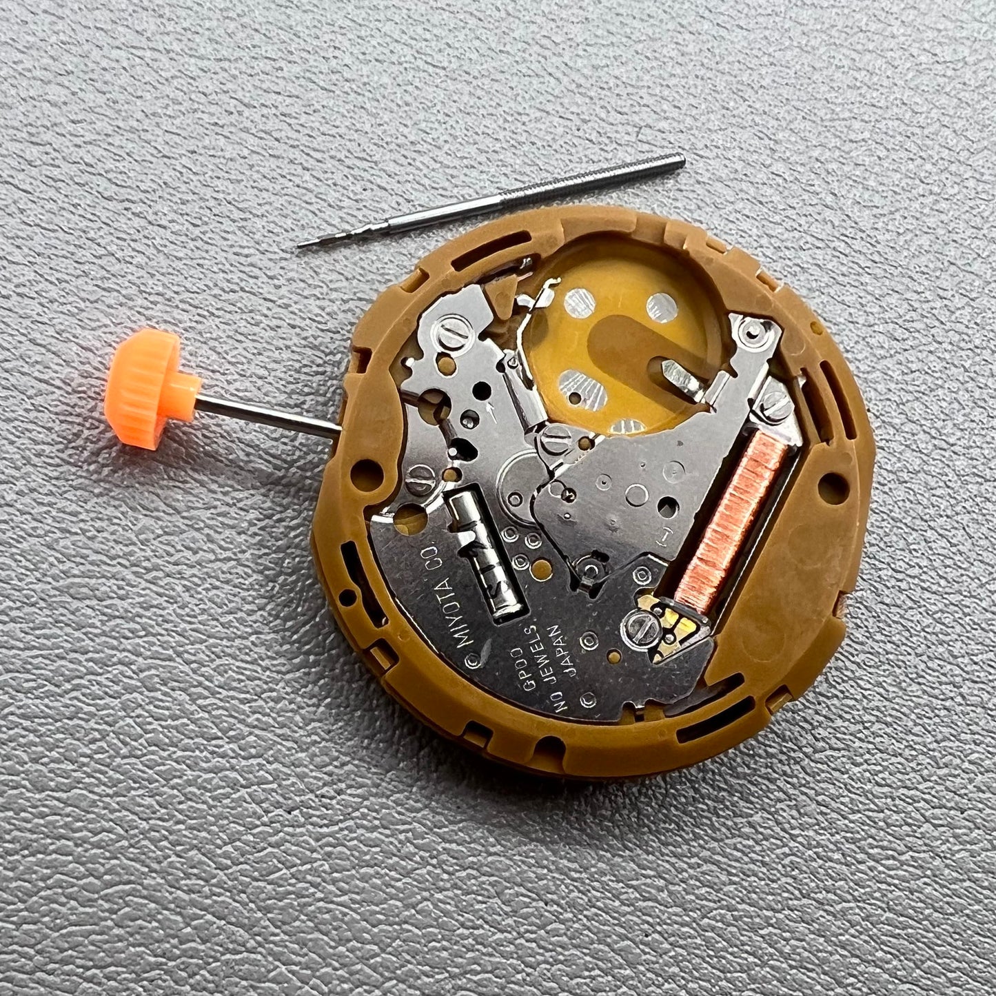 Japan Miyota GP00 quartz watch movement close-up, precision timekeeping mechanism for watches.