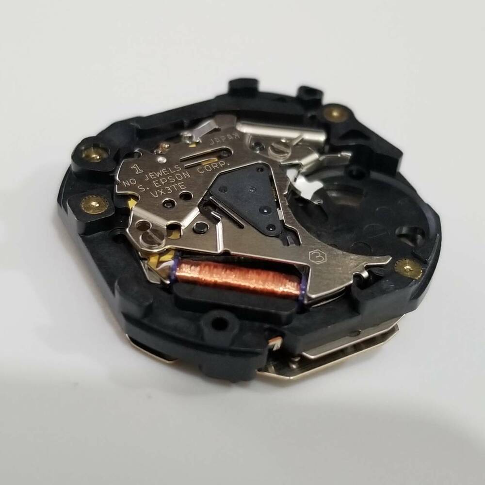 S. Epson VX3T quartz watch repair part displaying precise gear and coil components for accurate timekeeping.