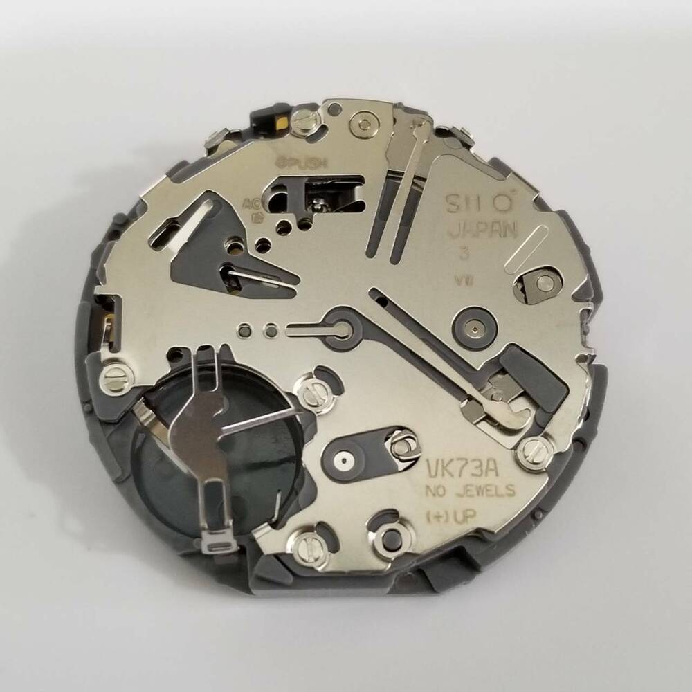 Hattori Epson TMI VK73 quartz watch movement, precise repair part for accurate timekeeping.