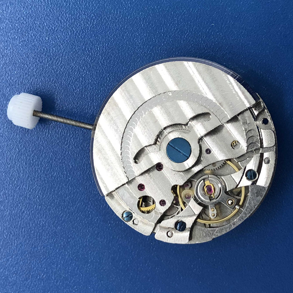 DG2813 automatic watch movement close-up displaying mechanical design, date function, and dual balance wheels.