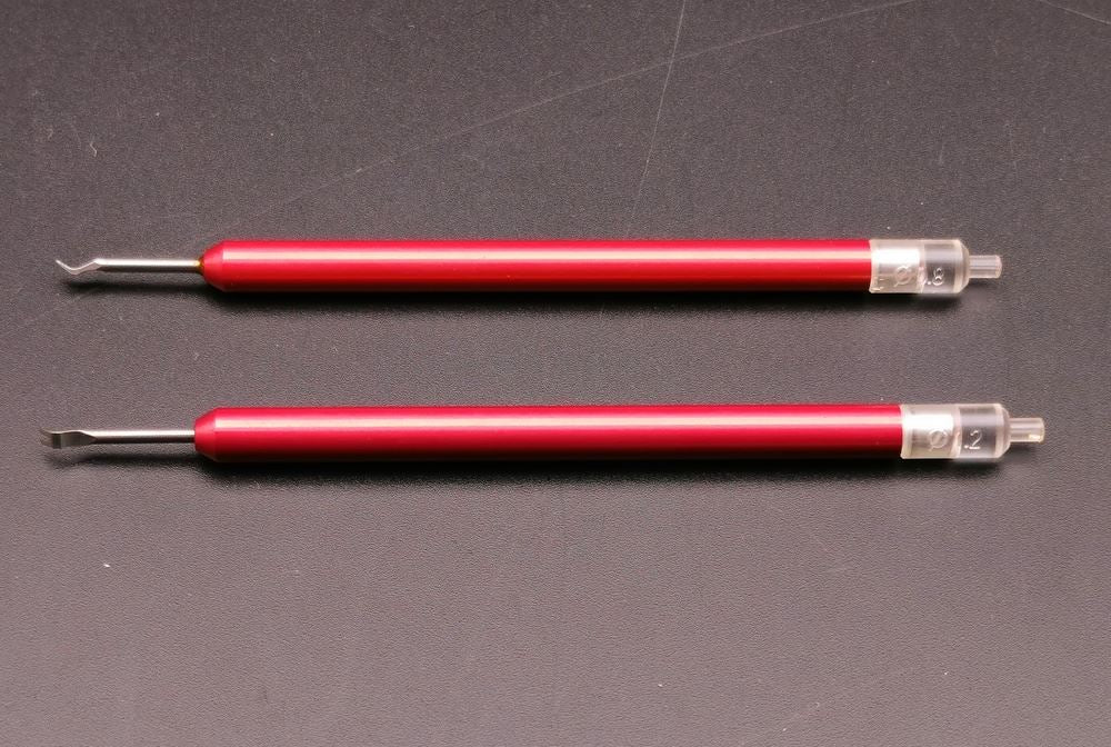 Rubber head needle punch tool set for accurate watch hand installation and repair.