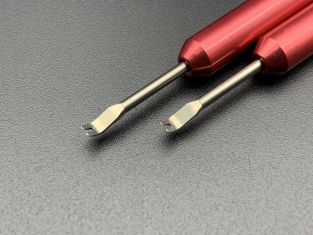 Rubber head needle punch tool set for precise watch hand installation and adjustment.