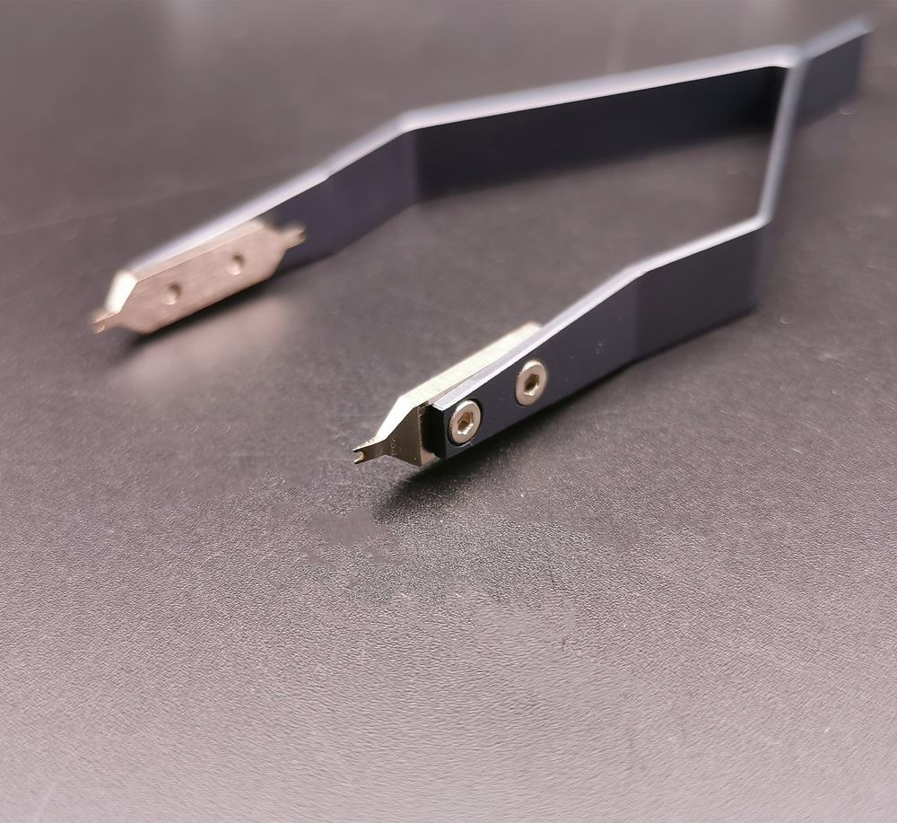 Precision stainless steel 7825 V type spring bar tweezers for detailed watch repair tasks.