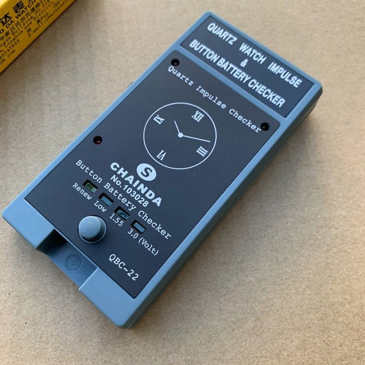 QBC-22 Quartz watch battery tester by QBC, compact tool for precise impulse button battery analysis.