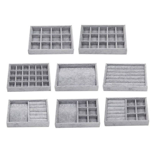 Stackable gray velvet jewelry organizer tray, ideal for displaying rings and necklaces.