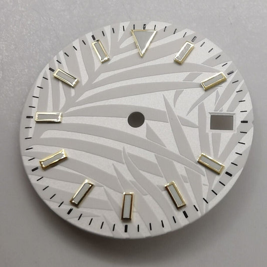 29mm green luminous watch dial for NH35 movement, set against a natural leaf background.