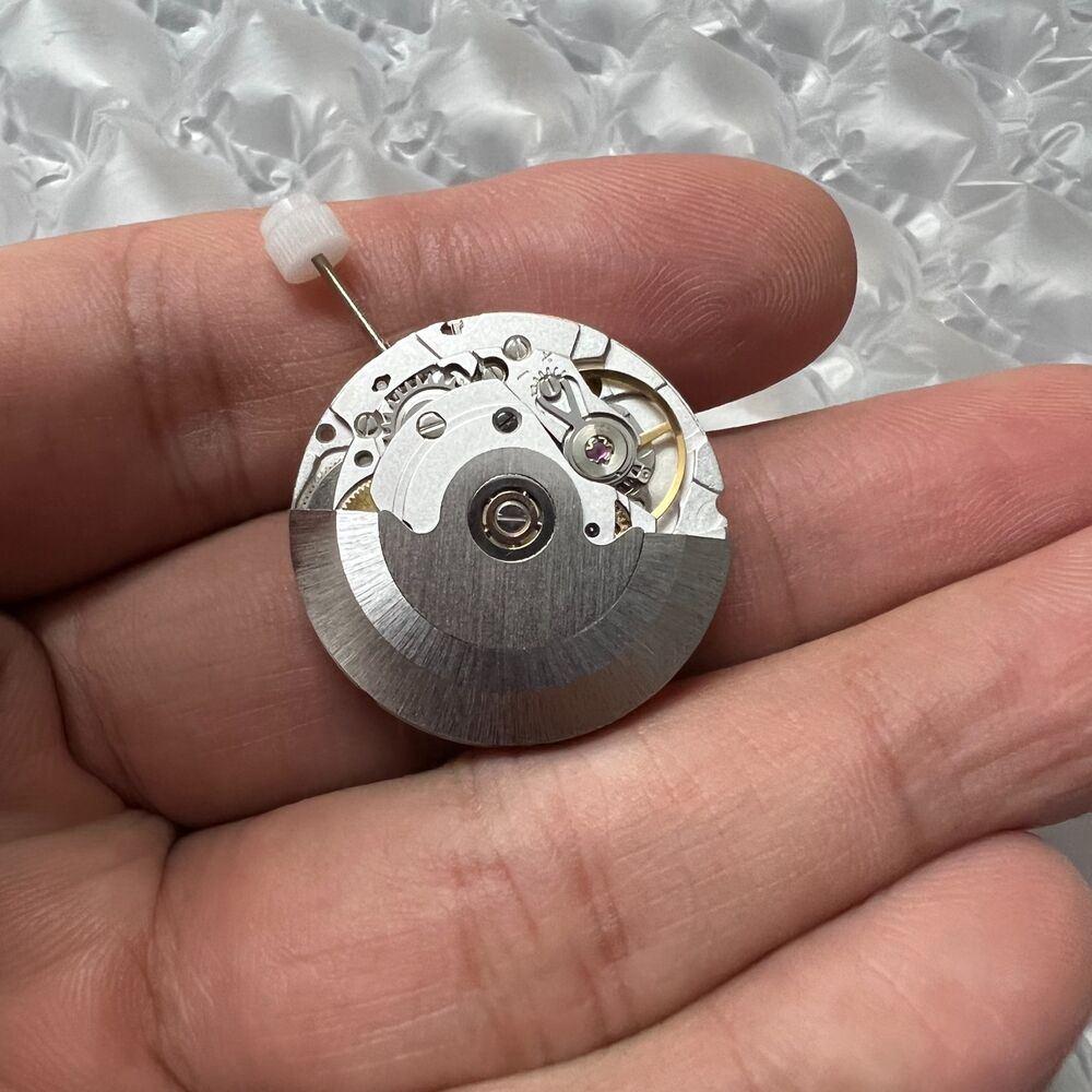 Silver Hangzhou HZ6460 watch showcasing 4 hands with automatic ETA 2836-2 GMT movement for accurate timekeeping.