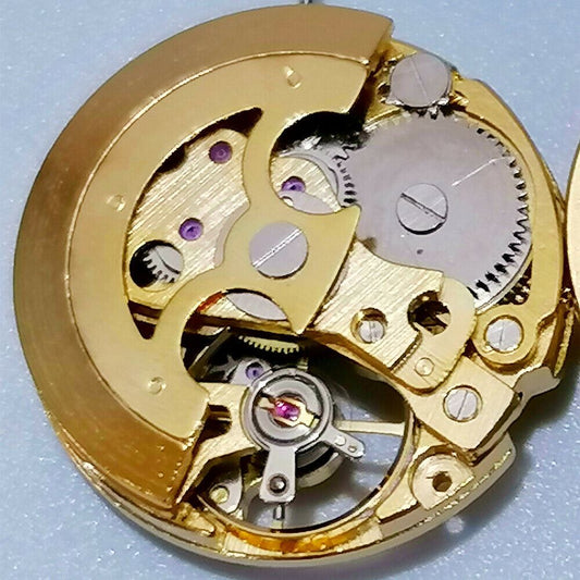Golden 26.5mm 7120 automatic mechanical watch movement with intricate hollow design.