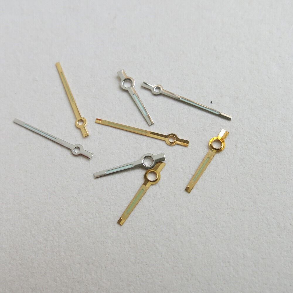 Set of 44 luminous watch hands in yellow and white, including hour, minute, and second hands for precise timekeeping.