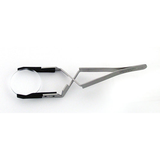 Bergeon 7140 cross locking tweezers holding watch crystals and dials for precise accessory handling.