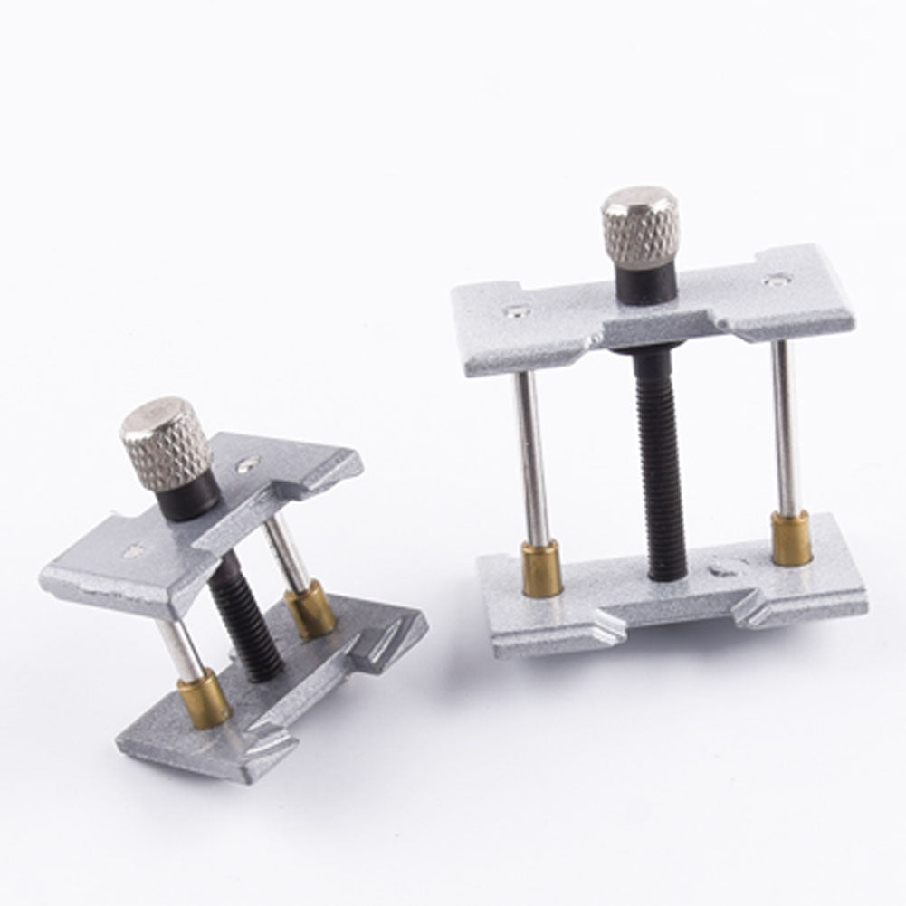 Precision metal watch movement holder clamp for secure repairs and precise adjustments.