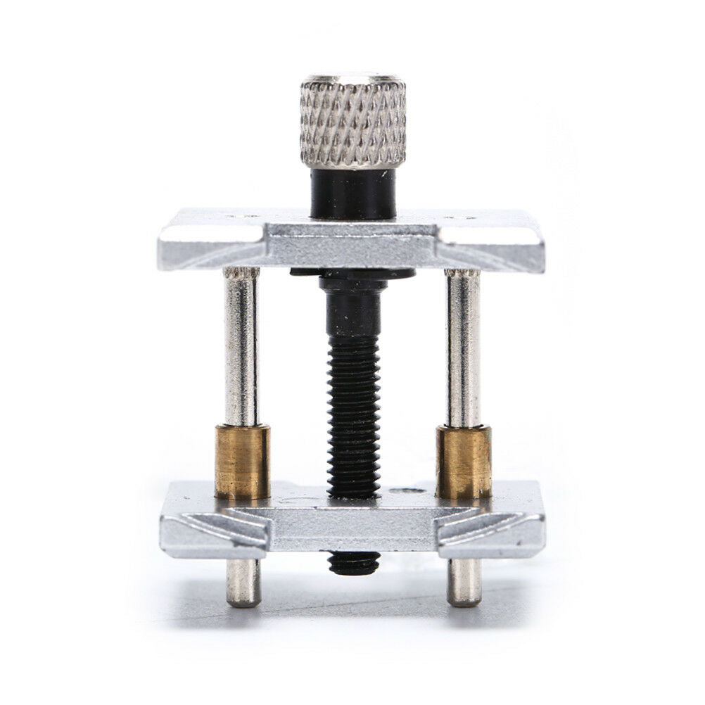 Precision metal watch movement holder clamp for secure watch repairs and adjustments.