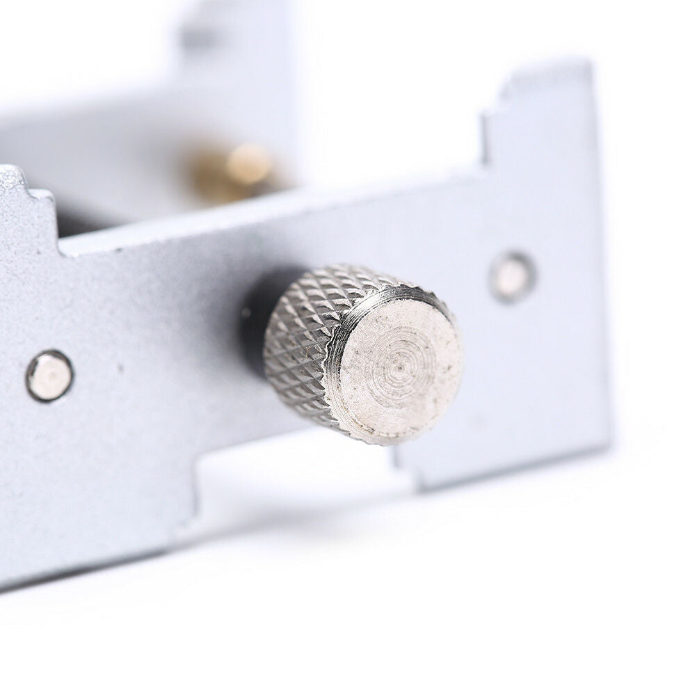 Precision metal watch movement holder clamp for secure repairs and precise adjustments.
