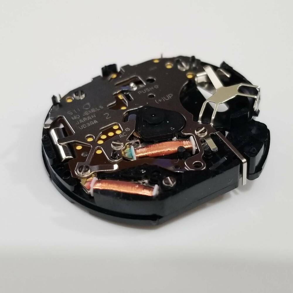 Hattori Epson TMI VD34A quartz watch movement, precise Japanese craftsmanship for watch repairs.