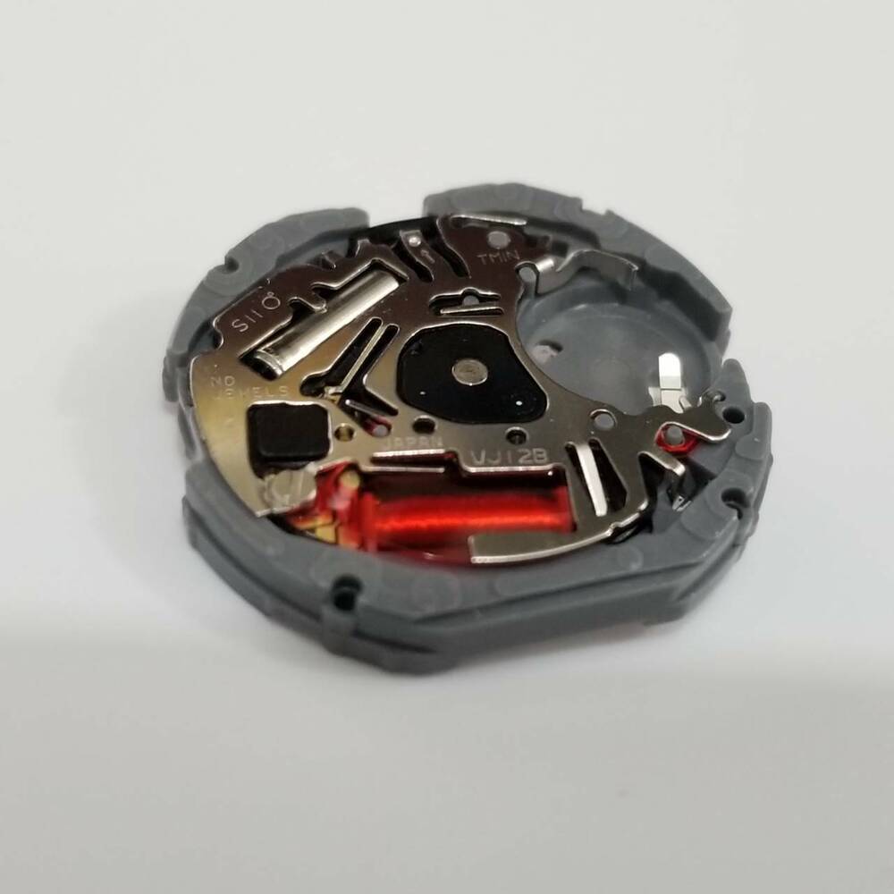 Hattori Epson TMI VJ12B quartz watch movement with date display at 3, precision Japanese craftsmanship.