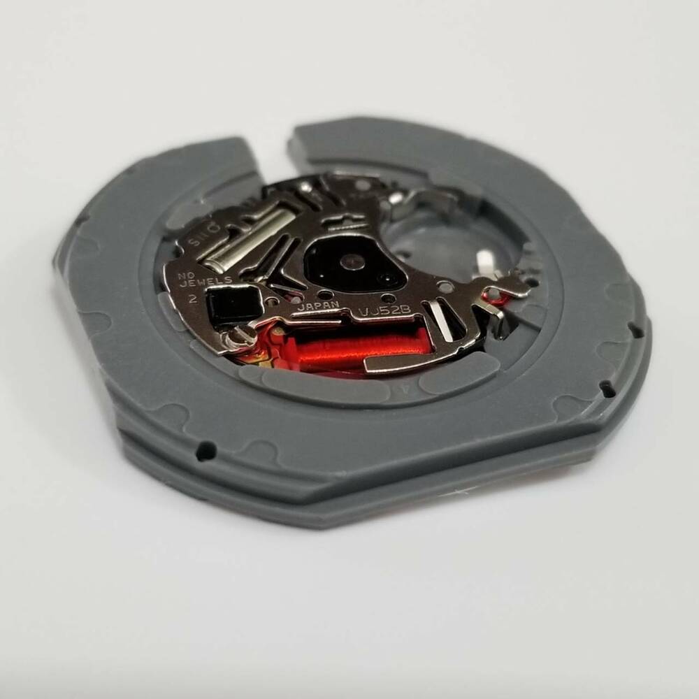 Hattori Epson VJ52B quartz watch movement showing date window at 3 o?clock, precise Japanese engineering.
