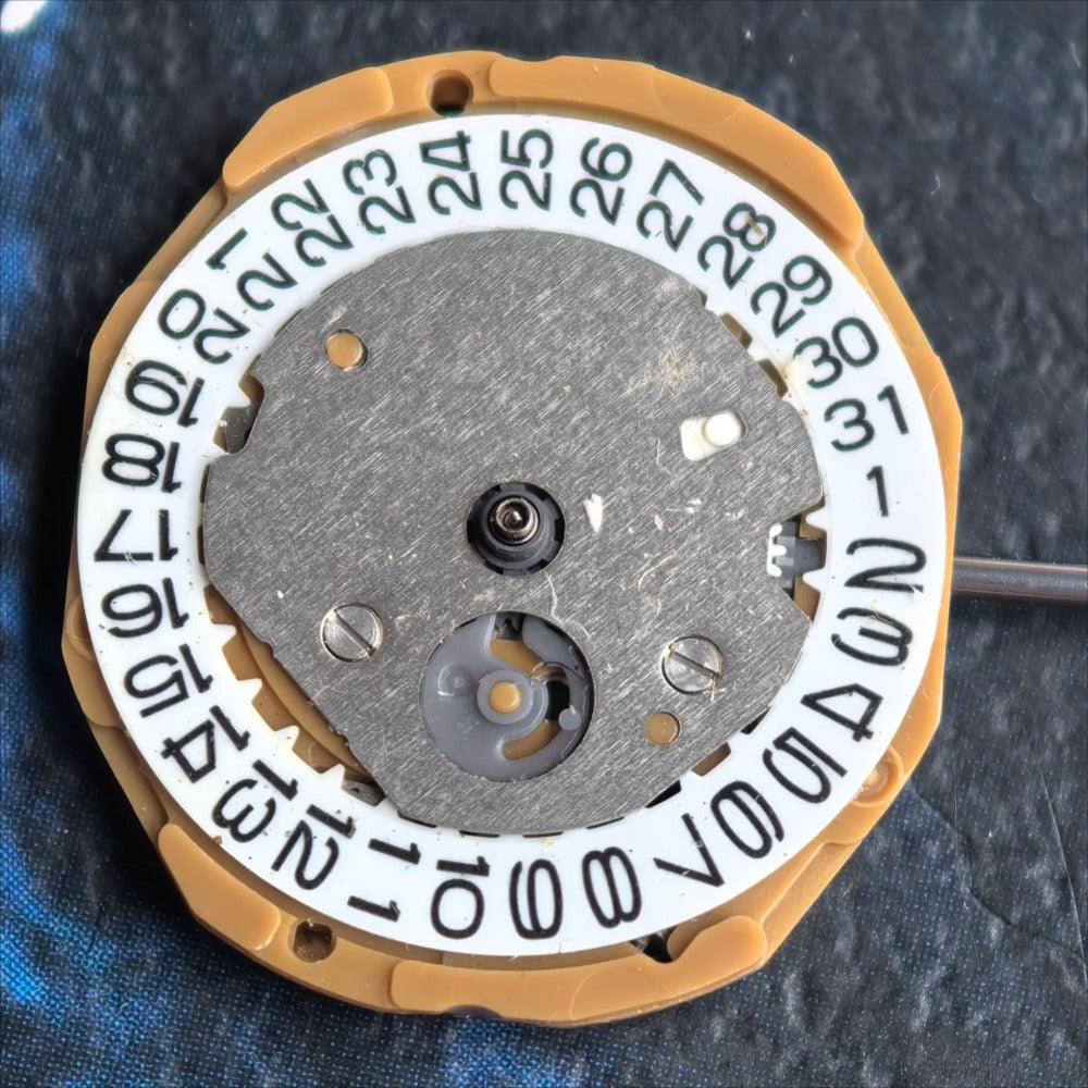 Miyota GL10 quartz watch movement showing three hands and date at 3 o'clock for precise timekeeping.