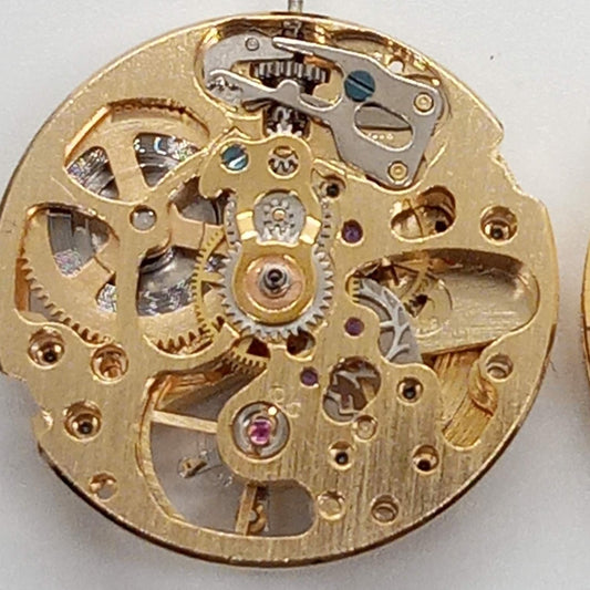 Dandong 7120 golden watch part with mechanical movement and skeleton 3-hand design for repairs.