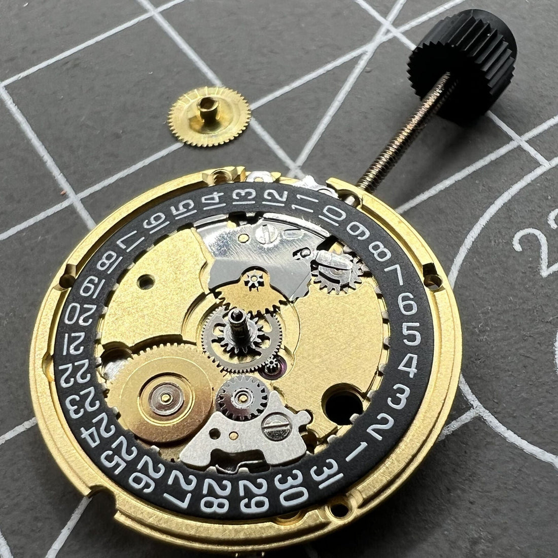 ETA 956.112 watch face with black disk and date at 3, featuring quartz movement, ideal for stylish timekeeping.