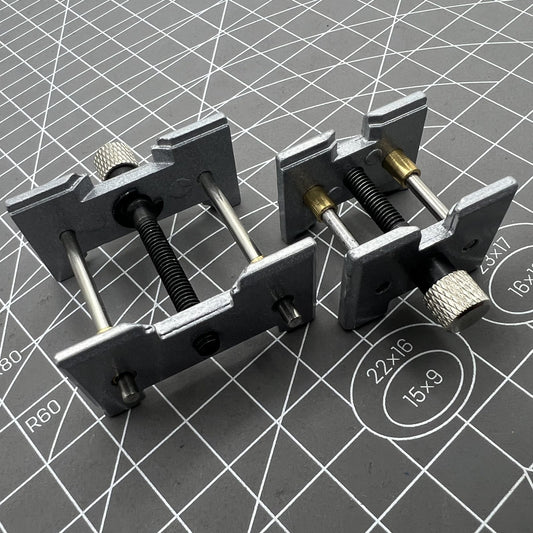 Set of 2 metal watch movement holders for precise watch repair and assembly, ideal for watchmakers.