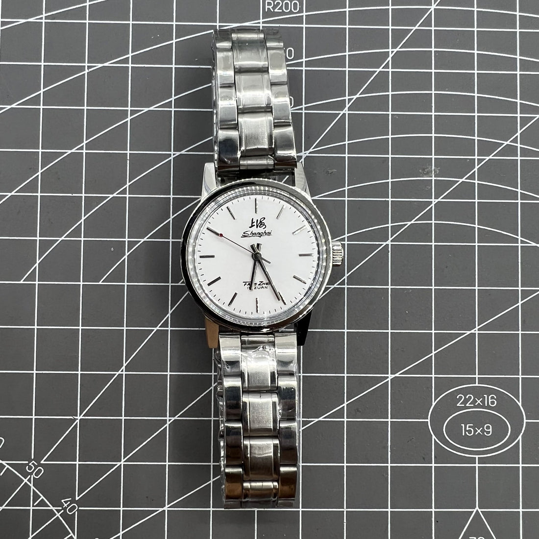 Silver 32mm Shanghai Factory manual mechanical watch with 19 jewels, shock-resistant design for durability.
