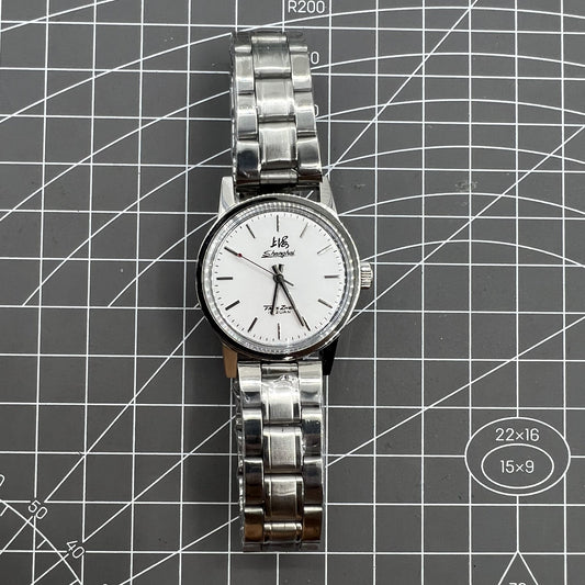 Silver 32mm Shanghai Factory manual mechanical watch with 19 jewels, shock-resistant design for durability.