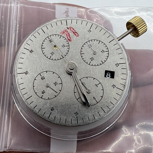 Black Dandong 7753 automatic watch with mechanical movement and small seconds at 9, China made.