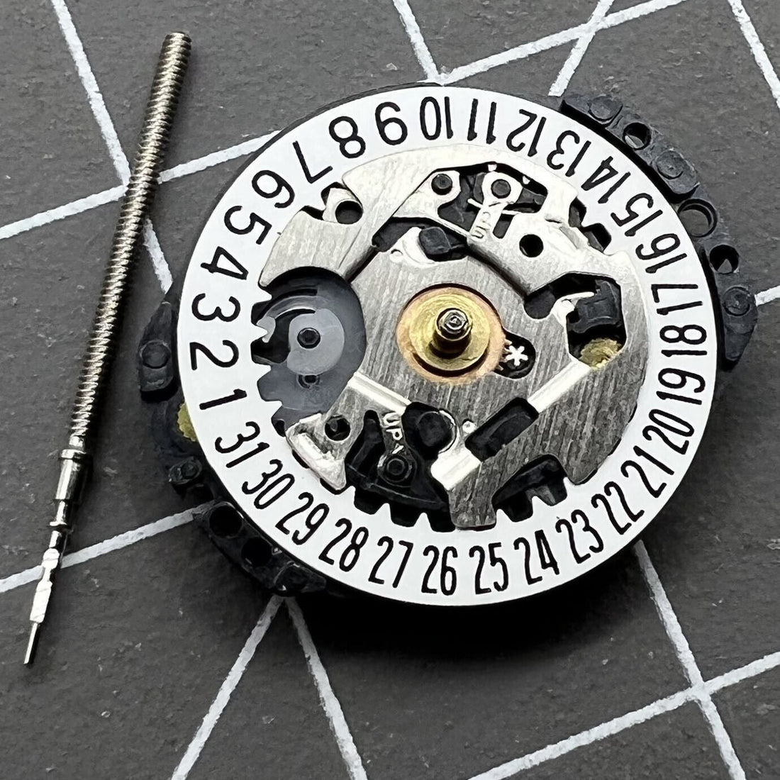 Japan Hattori Epson TMI VX89E quartz watch movement with stem and date display at 6 o'clock position