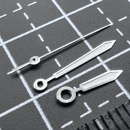 White arrow-shaped watch hands set for Miyota 2035 quartz movement, ideal for watch repairs and customization.