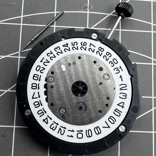 Miyota 6S20 quartz watch movement with date at 3, small second hands at 3, 6, and 9 positions.
