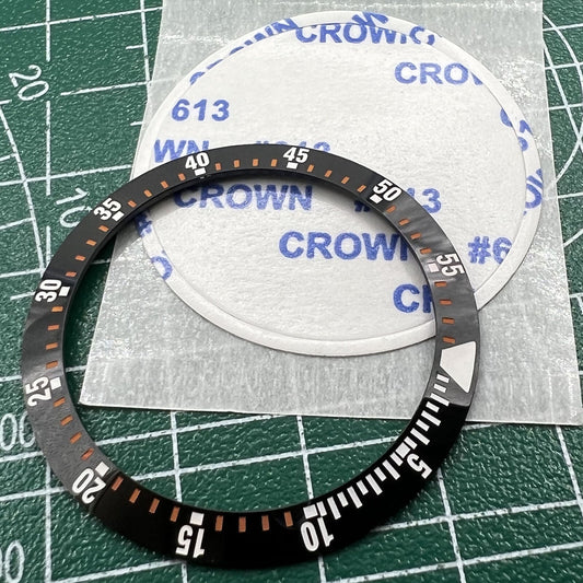 Black ceramic watch bezel insert with orange graduation, 38mm/30.5mm size, ideal for watch repairs.