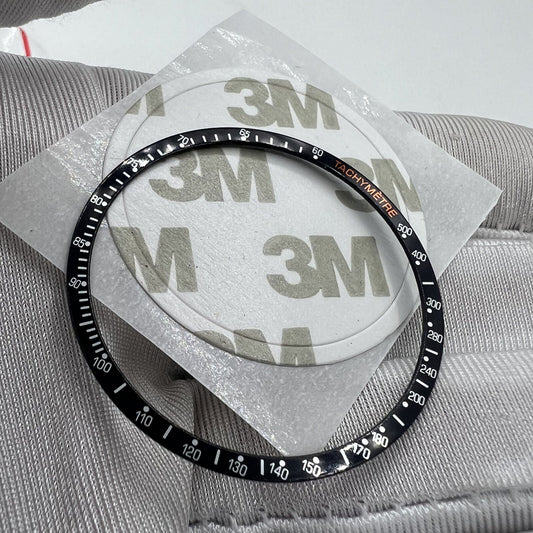 Black aluminum alloy 38.5mm watch bezel with white font for Omega Speedmaster, durable accessory.