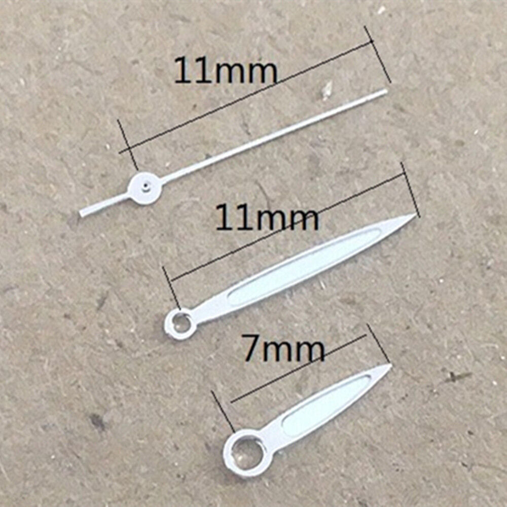 11mm silver arrow-shaped watch hands with green lume for Miyota 1M12 movement, perfect for precise time reading.