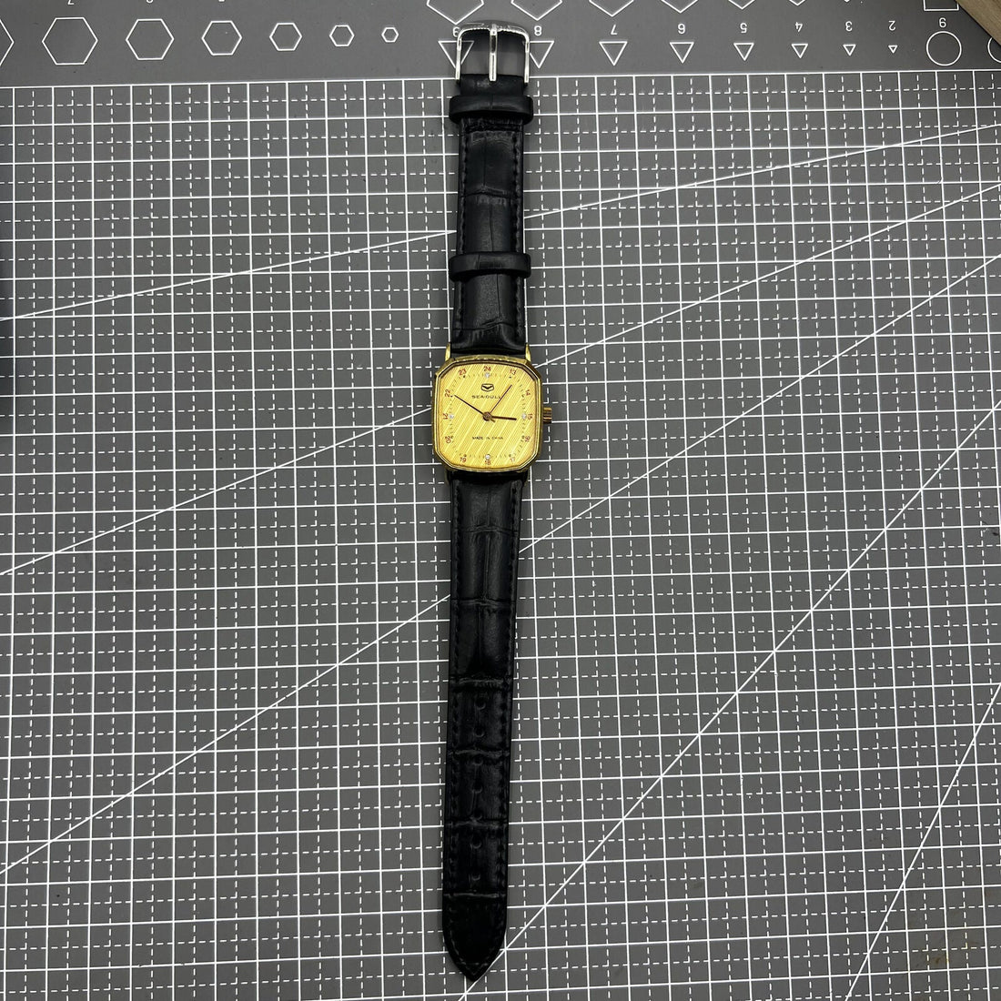 Tianjin Seagull 28mm octagonal gold case watch with golden dial, manual mechanical movement craftsmanship.