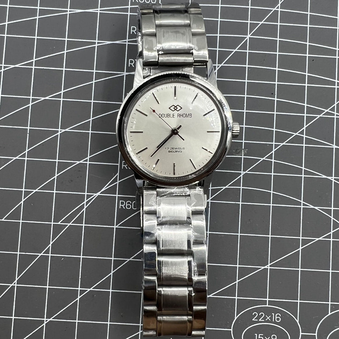 Silver 36mm Beijing Double Rhomb manual mechanical watch with silver case and nail markers, elegant accessory by Beijing.