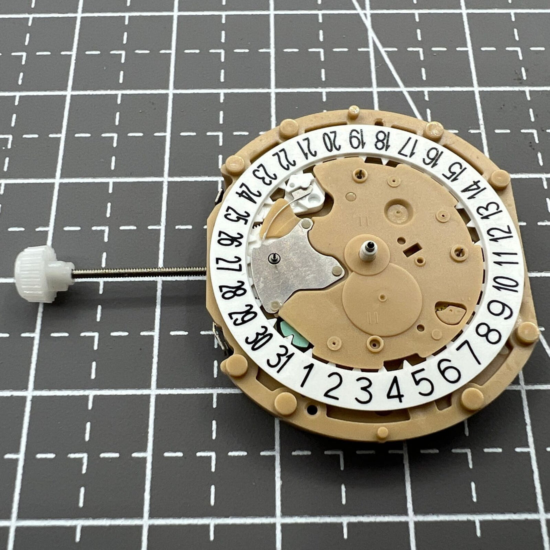 Sunon PE60 quartz watch movement with 3 hands and date display at 6 o'clock.