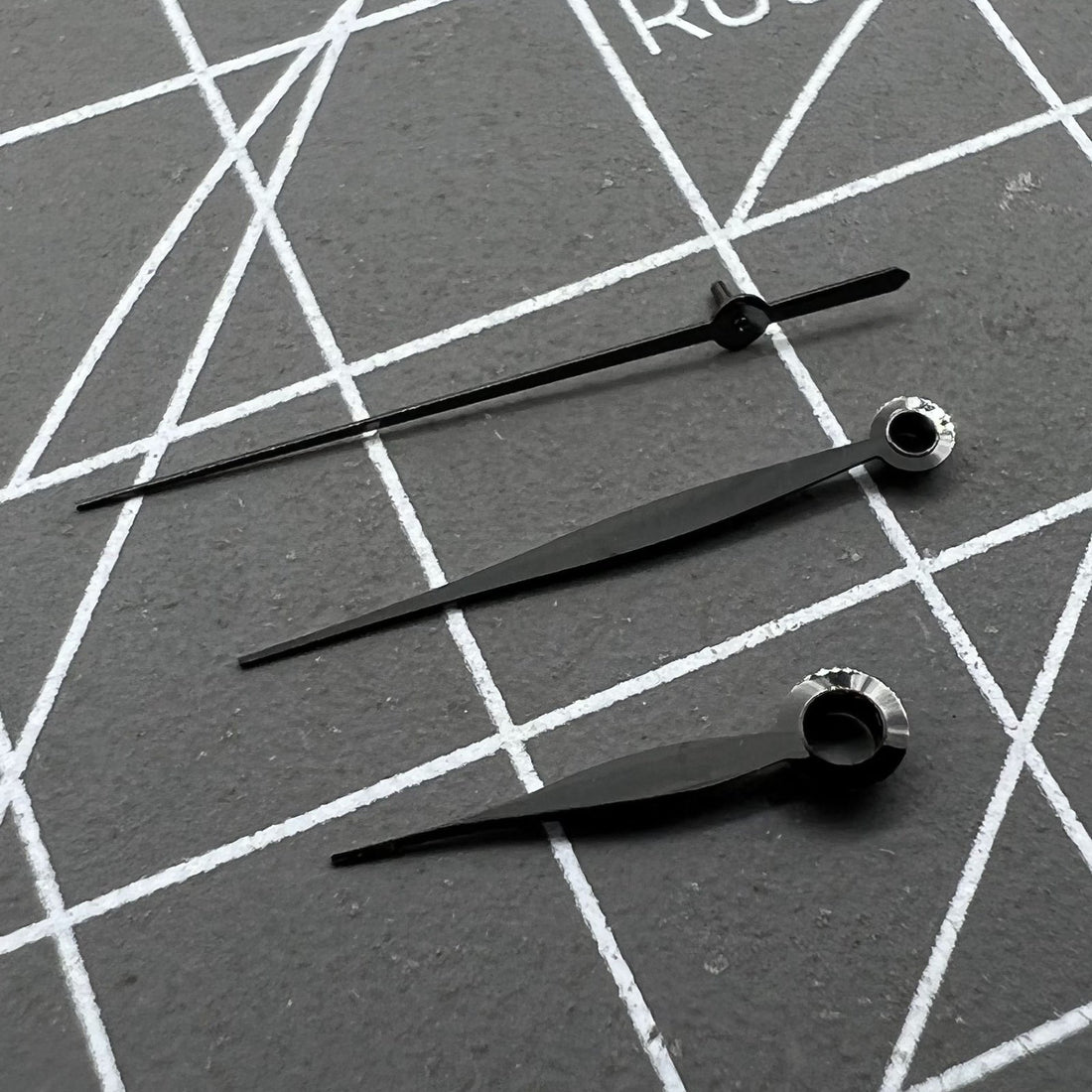 Polished black leaf-shaped watch hands set for LB06 movement, precise fit for luxury timepieces.