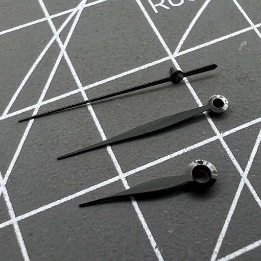 Polished black leaf-shaped watch hands set for LB06 movement, precise fit for luxury timepieces.