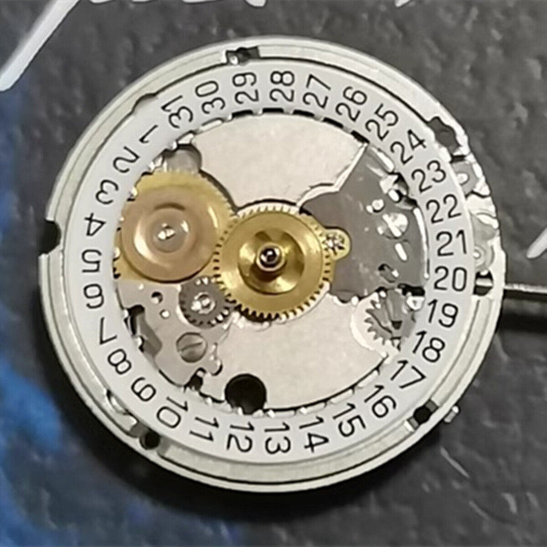 Swiss Made watch with ETA 556.115 quartz movement, three hands, and single calendar date at 3 o'clock.