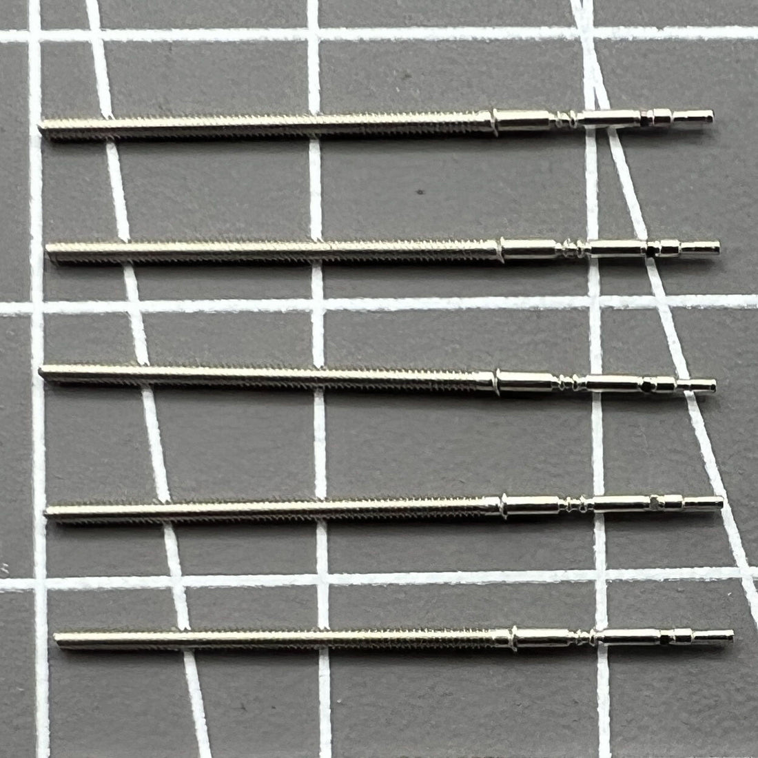 Set of 5 replacement winding stems for PE90 watch movement, precision fit for repair and maintenance.