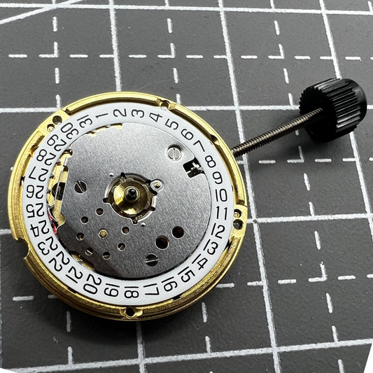 ETA F03.115 quartz watch movement showing three hands and date at 3, precision timekeeping by ETA.