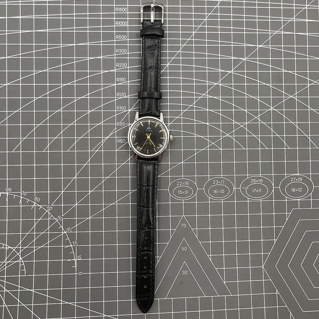 Taihang 32mm manual mechanical watch with black dial, golden nail markers, 17 jewels. Classic elegance for everyday wear.
