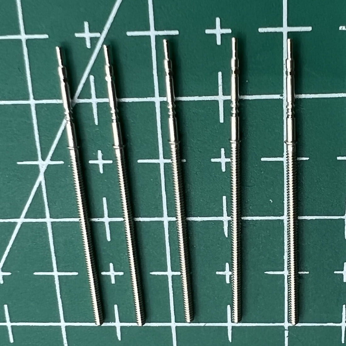Wholesale lot of replacement watch winding stems compatible with PE90 movement, durable watch repair parts.
