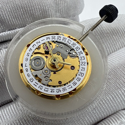 Golden mechanical watch movement ETA2671 replacement with date display at 3 o'clock.