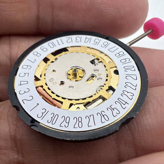 Ronda 715 Swiss quartz watch movement with date display at 3 and 6, golden finish replacement.
