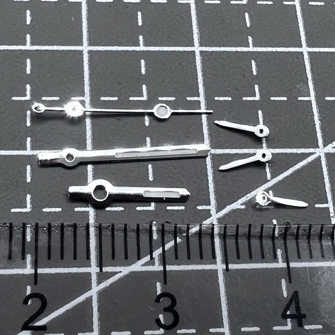 Silver arrow-shaped watch hands with green luminous trim, compatible with VD53 VD54 VD57 movements, 2 sets per pack.