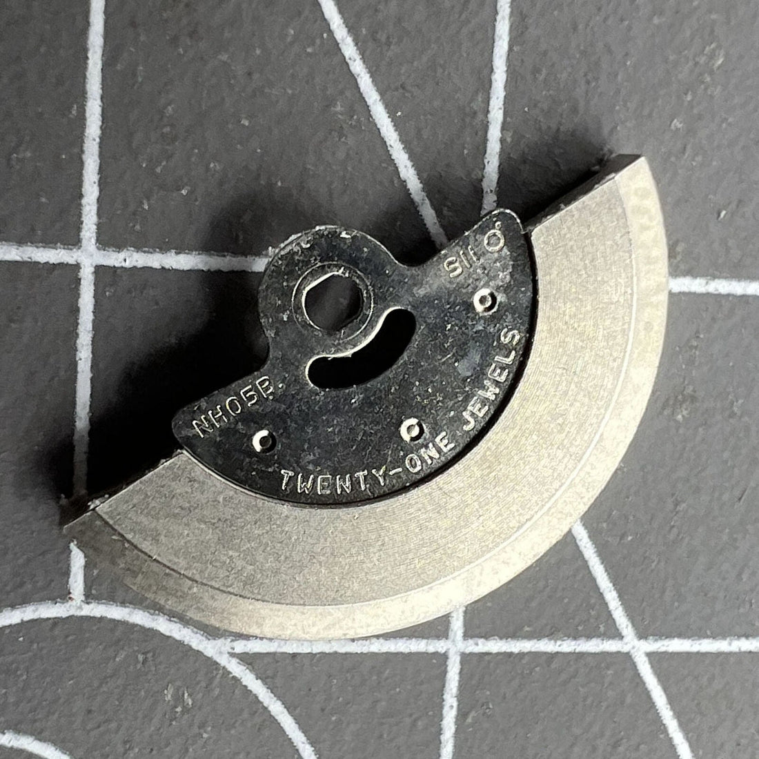 Silver rotor oscillating weight for NH05A/NH05B watch movement, compatible with various brands.