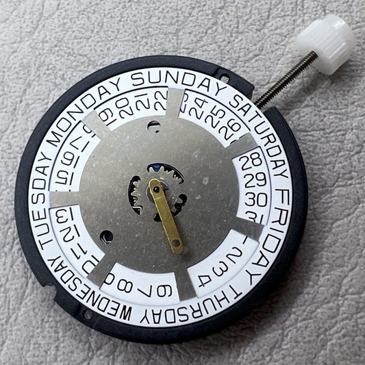 Swiss ETA 805.144 quartz movement watch mechanism with three hands on a silver white disk by ETA.